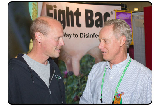 Dr. Geoff Westfall (right) discusses proper teat disinfection protocol with dairy producer/Fight Bac customer Mark Thomas.